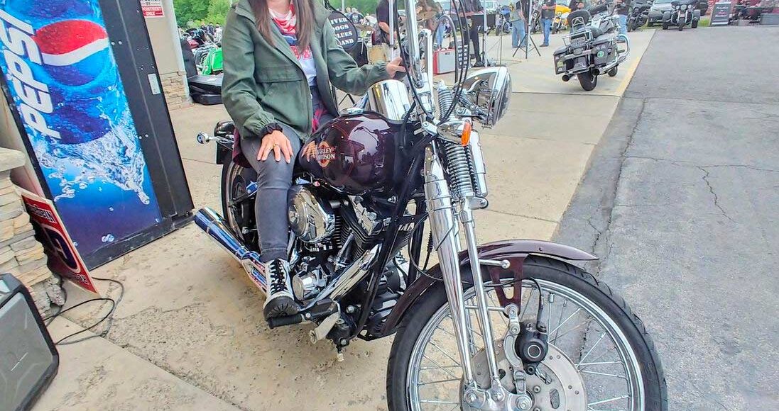 Attorney Christina Gullo sits on a Harley-Davidson Springer Softail