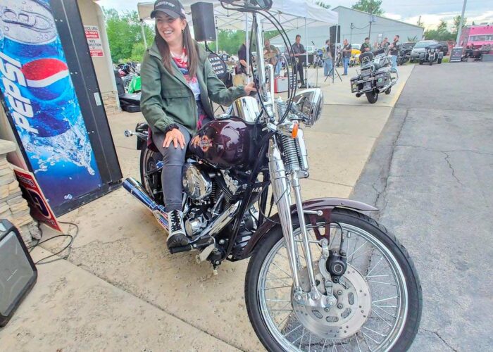 Attorney Christina Gullo sits on a Harley-Davidson Springer Softail