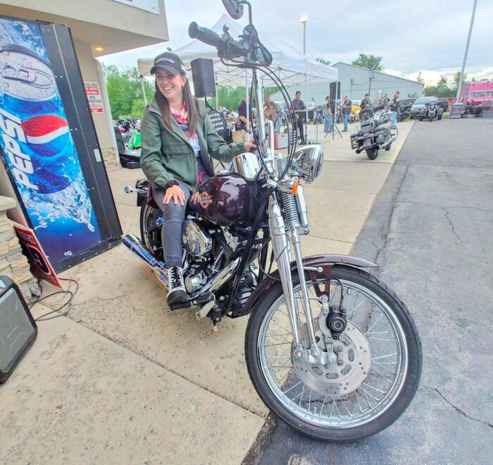 Attorney Christina Gullo sits on a Harley-Davidson Springer Softail