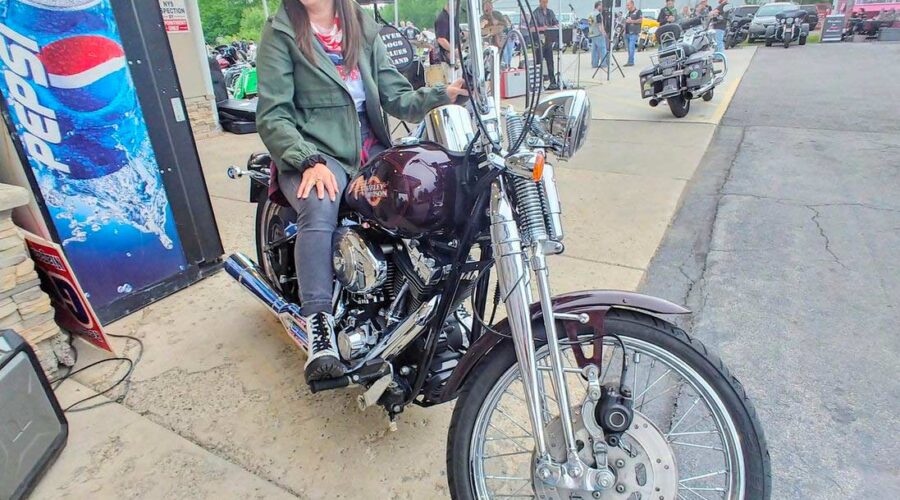 Attorney Christina Gullo sits on a Harley-Davidson Springer Softail