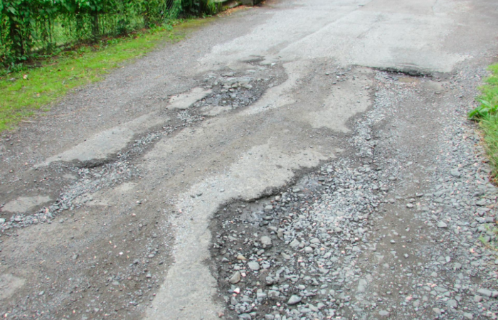 A road that has a badly degraded surface due to erosion