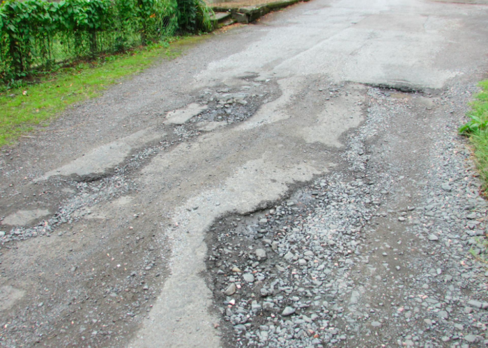 A road that has a badly degraded surface due to erosion