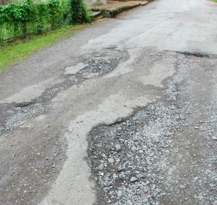 A road that has a badly degraded surface due to erosion