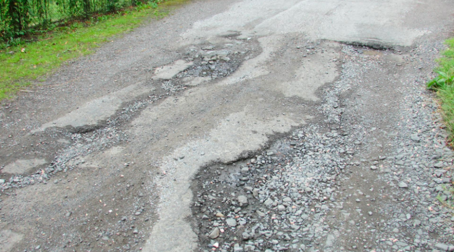 A road that has a badly degraded surface due to erosion