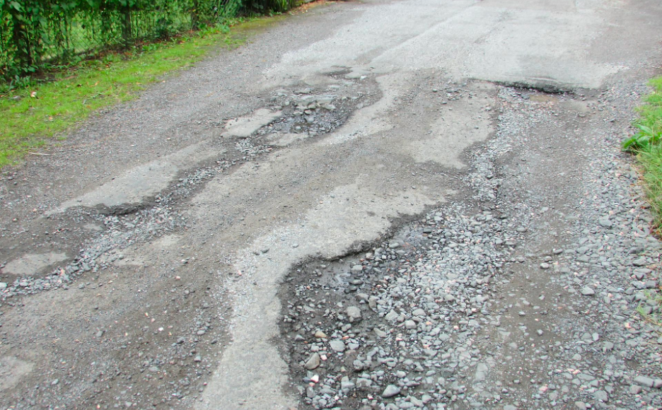 A road that has a badly degraded surface due to erosion