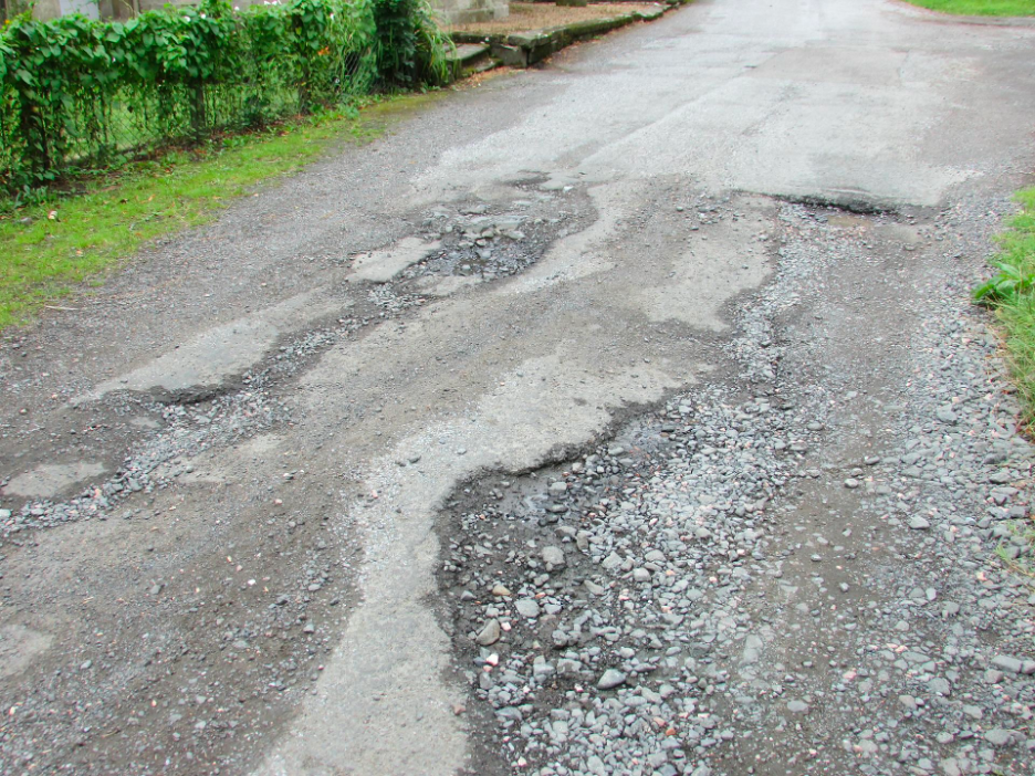 A road that has a badly degraded surface due to erosion