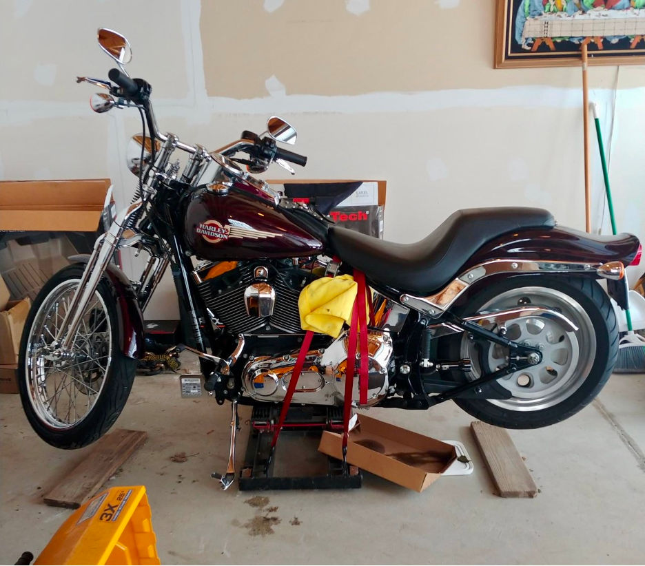 2006 Harley-Davidson Springer Softail strapped up on a jack for winter storage