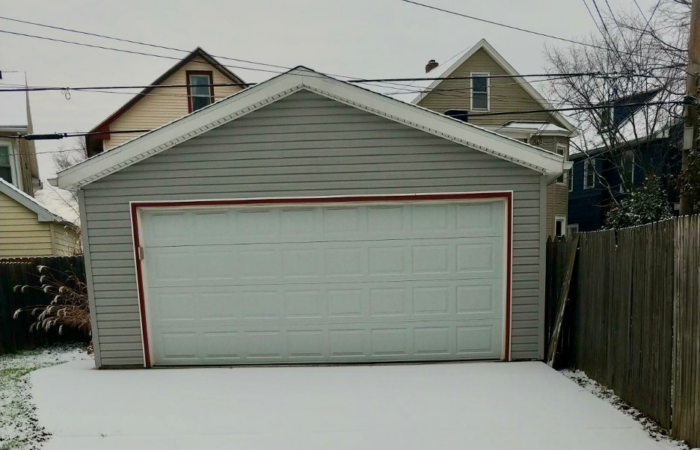 Garage in Buffalo, NY with snow on the driveway in front of it