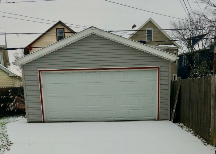 Garage in Buffalo, NY with snow on the driveway in front of it