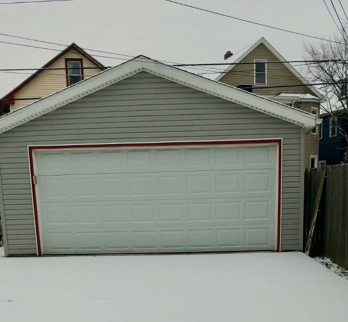 Garage in Buffalo, NY with snow on the driveway in front of it