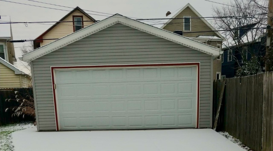 Garage in Buffalo, NY with snow on the driveway in front of it