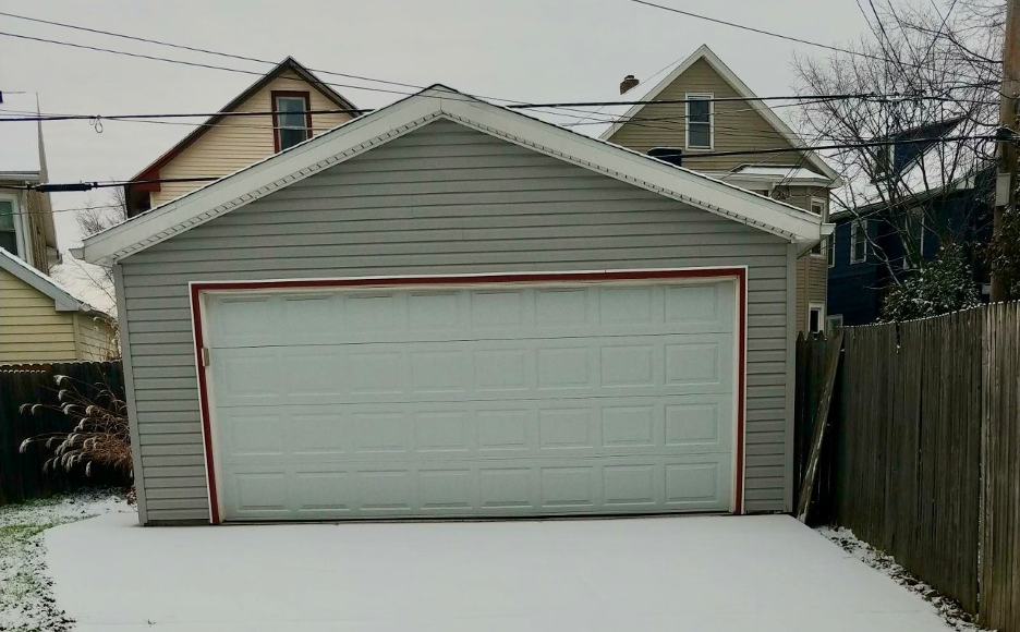 Garage in Buffalo, NY with snow on the driveway in front of it