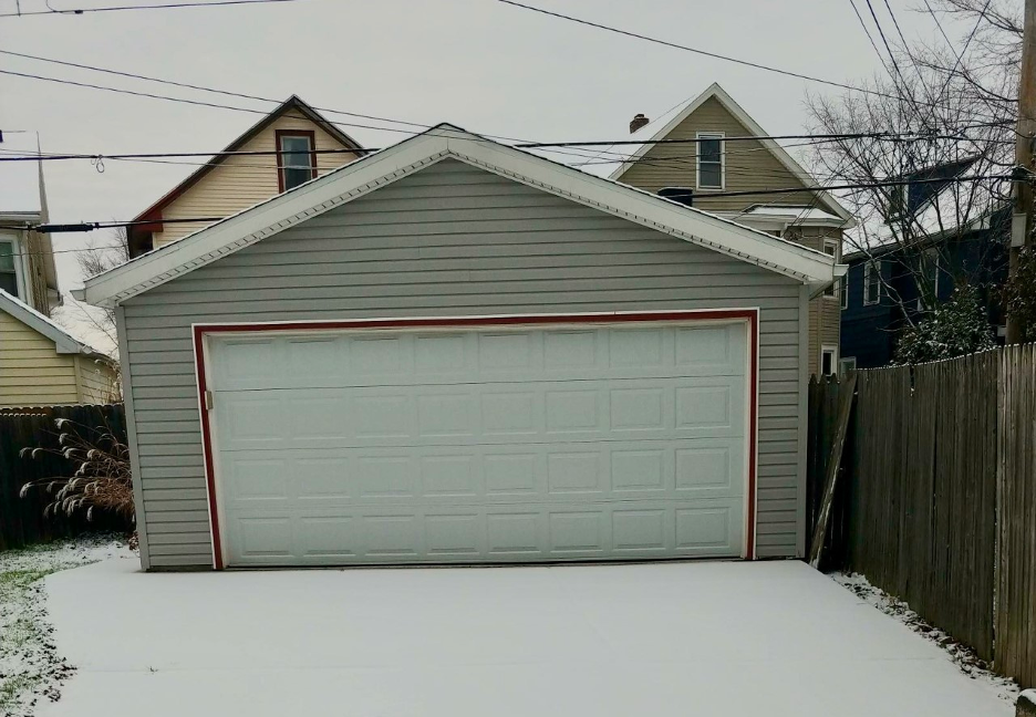 Garage in Buffalo, NY with snow on the driveway in front of it