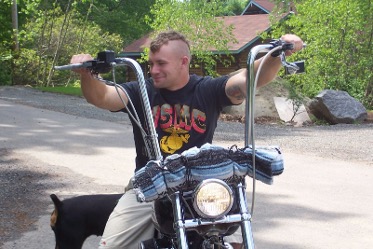 Kade O'Brien sitting on his Harley-Davidson