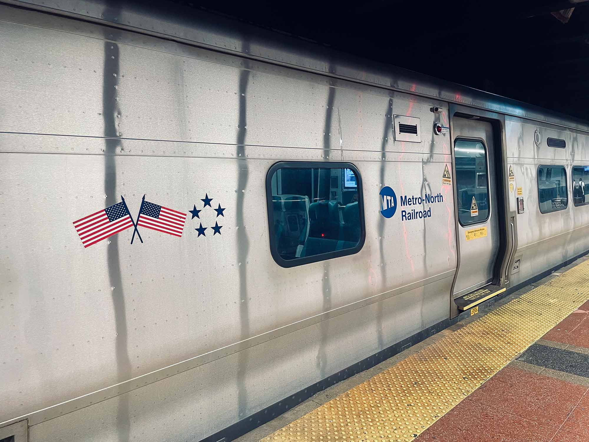 Metro North commuter rail car with doors closed at a station in New York City