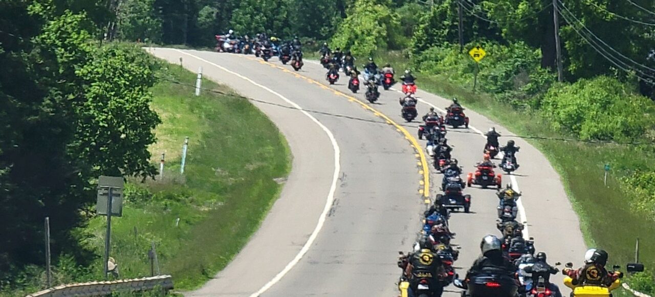 Motorcycle riders and members of the Combat Vets Motorcycle Association move together down the road in staggered formation to raise awareness for Veteran Suicide.