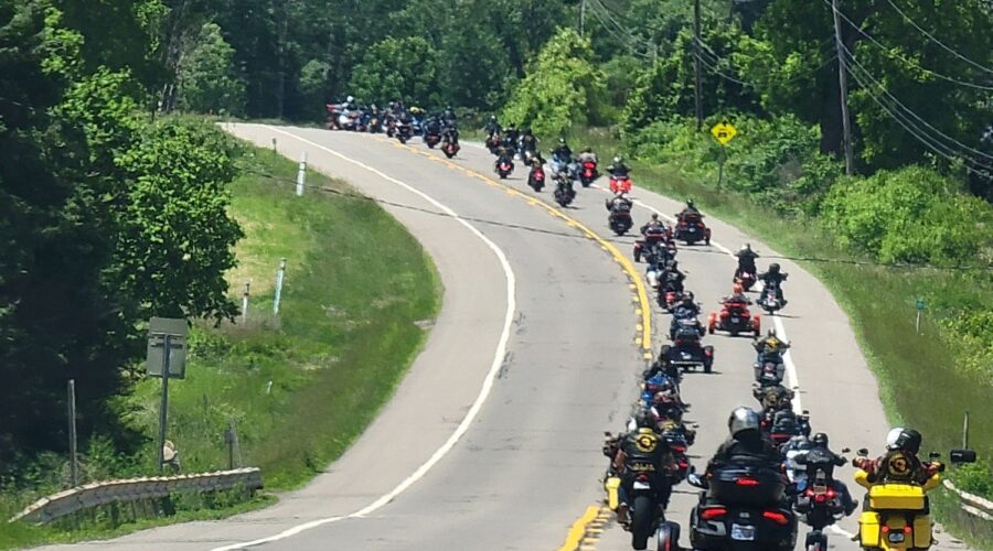 Motorcycle riders and members of the Combat Vets Motorcycle Association move together down the road in staggered formation to raise awareness for Veteran Suicide.