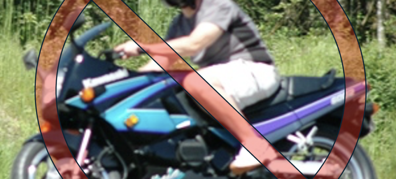 Motorcycle rider wearing shorts and a t-shirt