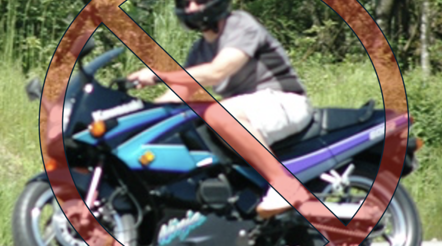 Motorcycle rider wearing shorts and a t-shirt