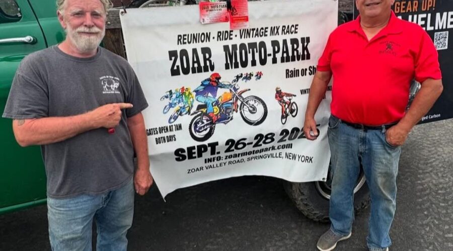 John Watson and Ed Abdo stand in front of a banner promoting the Zoar Moto-Park Reunion to be held September 26 - 28, 2025