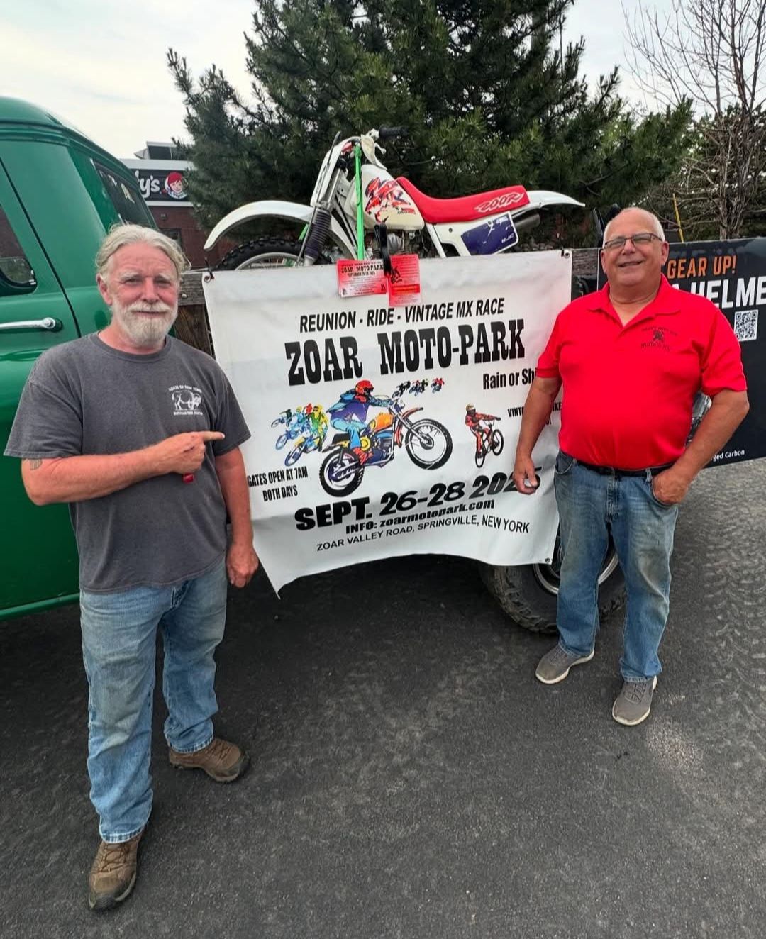 John Watson and Ed Abdo stand in front of a banner promoting the Zoar Moto-Park Reunion to be held September 26 - 28, 2025